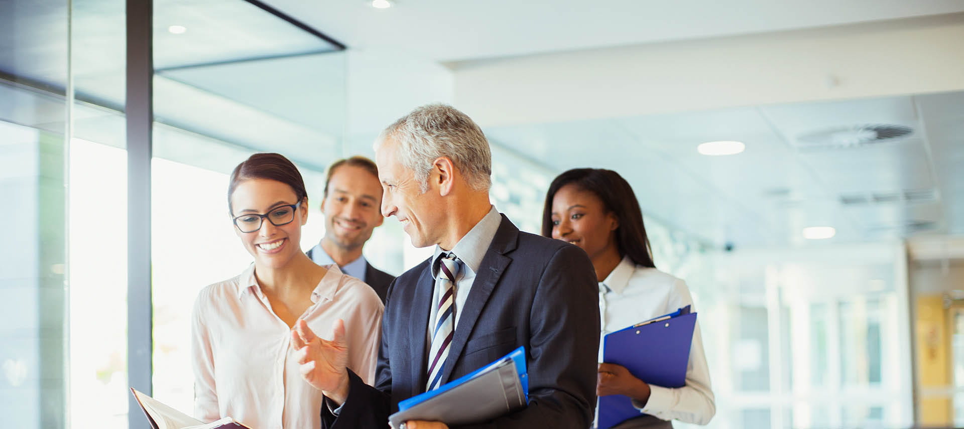 Business people talking and walking in office.