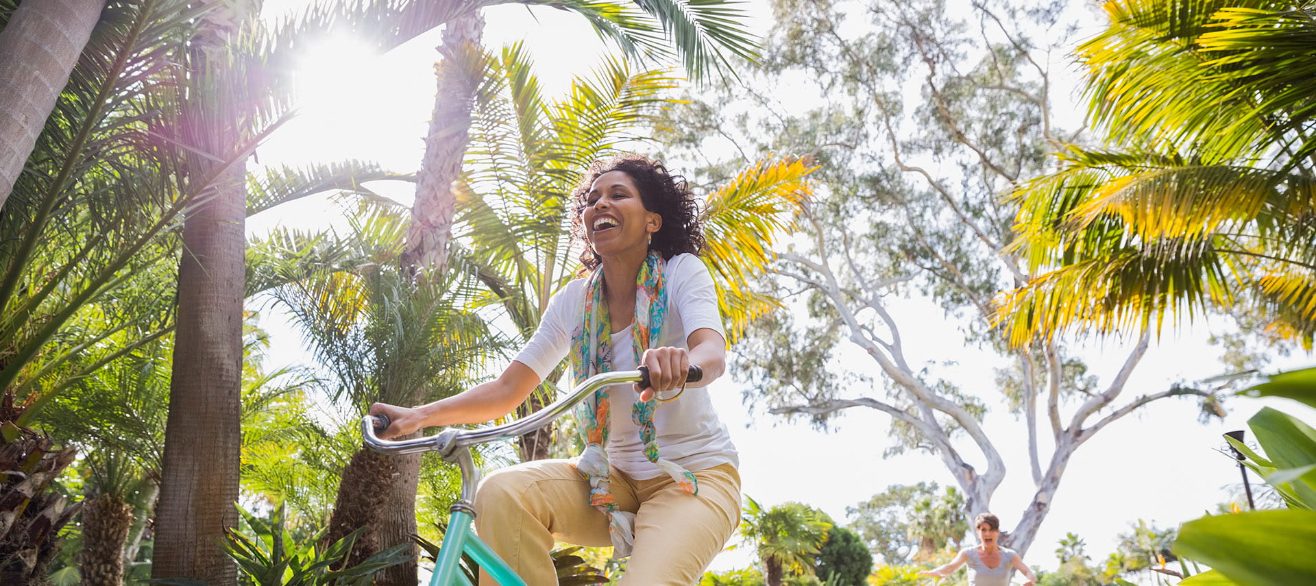 Female enjoying a sunny bicycle ride .
